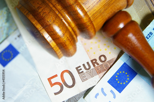 Photo: Closeup of a gavel and Euro notes Closeup of a gavel and Euro notes