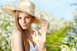 portrait of young lovely woman in spring flowers over amazing ga