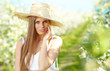 portrait of young lovely woman in spring flowers over amazing ga