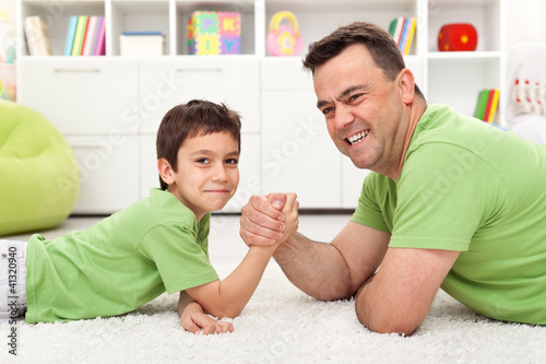 Photo: Father and son playing arm wrestling Father and son playing arm wrestling