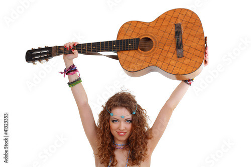 Photo: woman in hippie outfit holding guitar under her head woman in hippie outfit holding guitar under her head