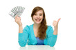 Woman holding money and showing thumbs up
