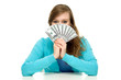 Female holding a fan of money over face