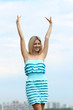 Young blond woman in sexy dress on background of the sky