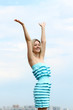 Young blond woman in sexy dress on background of the sky