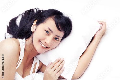 Photo: Cute Asian woman smiling on bed Cute Asian woman smiling on bed