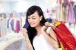Asian woman with shopping bag and a credit card
