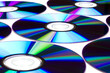 Pattern of cd/dvd disks over white