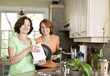 Women doing dishes in kitchen