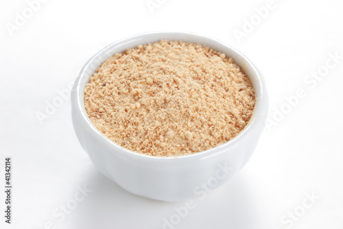 Photo: Ground Ginger (Zingiber officinale) in a white bowl on white bac Ground Ginger (Zingiber officinale) in a white bowl on white bac