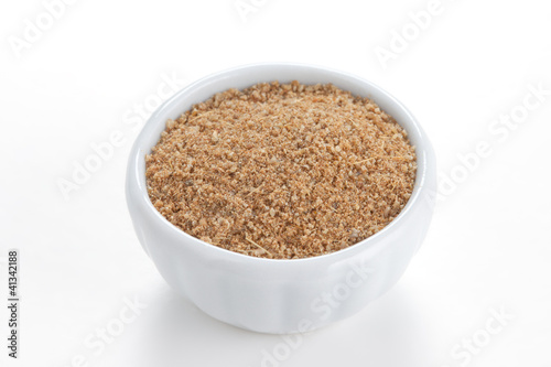Photo: Cumin ground in a white bowl on white background. Cumin ground in a white bowl on white background.
