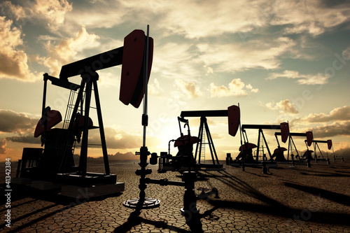 Illustrazione: Oil pumps on the sunset sky Oil pumps on the sunset sky