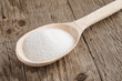 canvas print picture - Sugar in spoon on wooden background