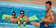 Young friends in swimming pool smiling