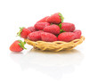 strawberries in a bowl of straw on a white background