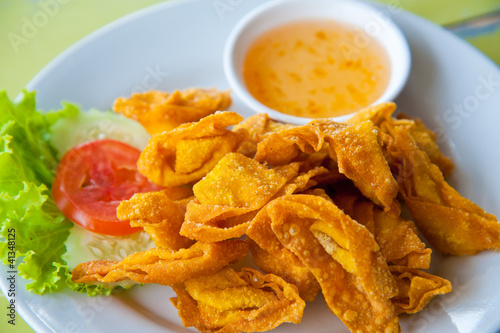 Photo: Deep Fried Wonton on white dish with plum sauce Deep Fried Wonton on white dish with plum sauce