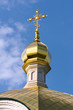 Close-up of Golden crucifix and Cupola of Orthodox church and bl