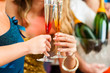 People in club or bar drinking champagne