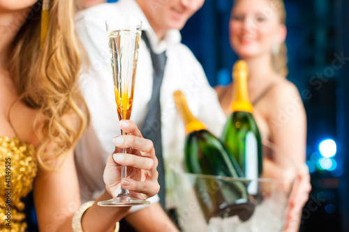 Photo: People in club or bar drinking champagne People in club or bar drinking champagne