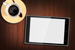 Tablet computer on Wood Table with a cup of coffee Tablet computer on Wood Table with a cup of coffee