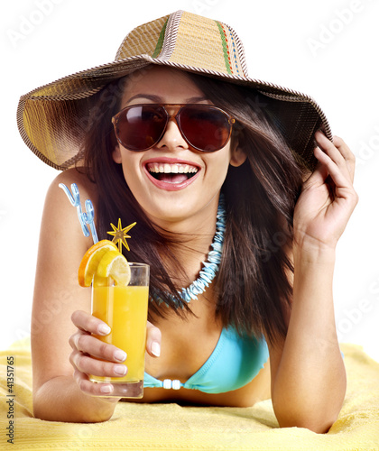 Photo: Woman on beach drinking cocktail. Woman on beach drinking cocktail.