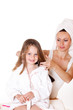 Mother brushing daughter's hair