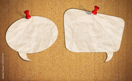 Photo: blank speech bubble note paper with push pins on cork board blank speech bubble note paper with push pins on cork board