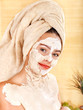 Young woman having clay body mask. Young woman having clay body mask.