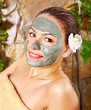 Woman having clay facial mask apply by beautician. Woman having clay facial mask apply by beautician.