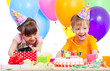 happy children celebrating birthday party with opening gift box