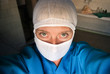 Photo: portrait of serious nurse or doctor in surgical mask portrait of serious nurse or doctor in surgical mask