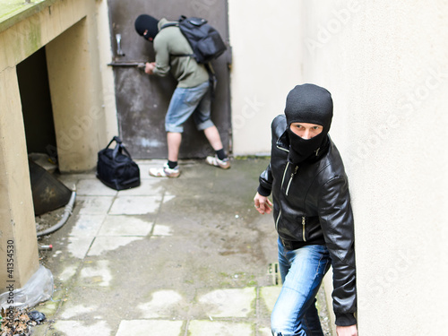 Photo: Burglar tries open the door. Second is on the lookout Burglar tries open the door. Second is on the lookout