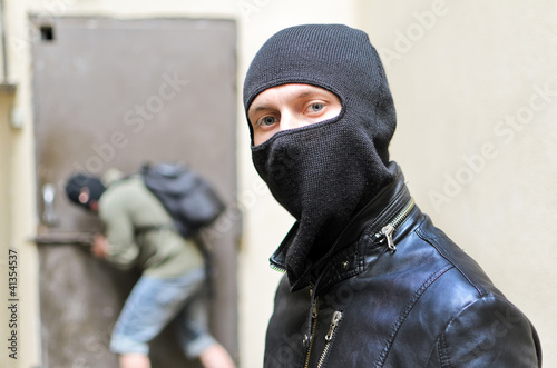 Photo: Burglar tries open the door. Second is on the lookout Burglar tries open the door. Second is on the lookout