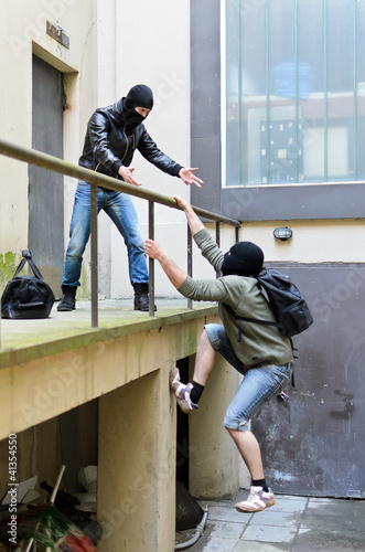 Photo: Escape from a robbery. One tries to help another Escape from a robbery. One tries to help another