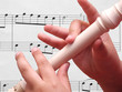 Child playing on white recorder