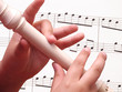 Child playing on white recorder
