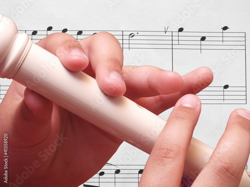 Photo: Child playing on white recorder Child playing on white recorder