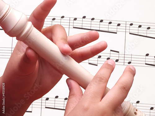 Photo: Child playing on white recorder Child playing on white recorder