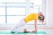 Foto: Pretty young woman doing YOGA exercise at home Pretty young woman doing YOGA exercise at home