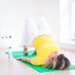 Foto: Pretty young woman doing YOGA exercise at home Pretty young woman doing YOGA exercise at home