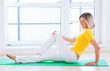 Foto: Pretty young woman doing YOGA exercise at home Pretty young woman doing YOGA exercise at home