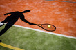 shadow of a tennis player in action on a tennis court shadow of a tennis player in action on a tennis court