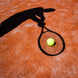 shadow of a tennis player in action on a tennis court shadow of a tennis player in action on a tennis court