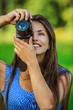 woman photographed with camera and smiling woman photographed with camera and smiling