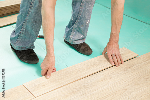 Photo: Man installing flooring Man installing flooring