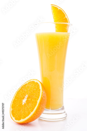 Photo: Half of am orange near a glass of orange juice Half of am orange near a glass of orange juice