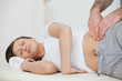 Peaceful woman being massaged by her practitioner Peaceful woman being massaged by her practitioner
