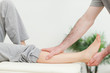 Photo: Close-up of the leg of a woman being stretched Close-up of the leg of a woman being stretched