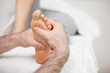 Man using his two hands to massage a foot
