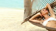 Happy young woman relaxing in a hammock